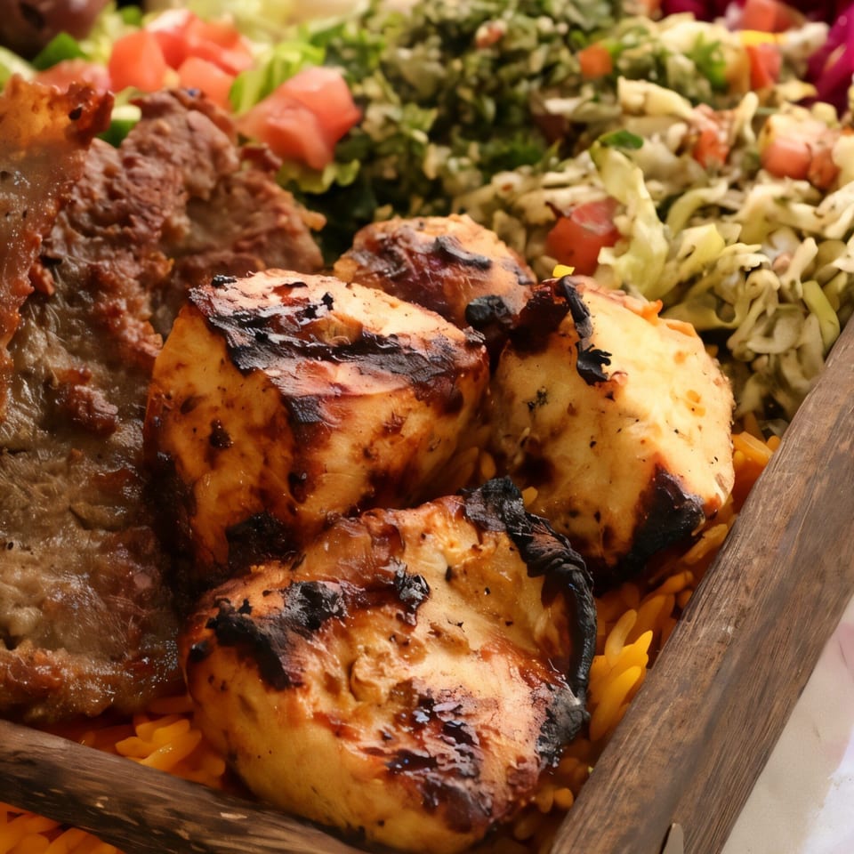 Grilled chicken and beef kebabs with rice and salad in a wooden tray at Killer Kabab.