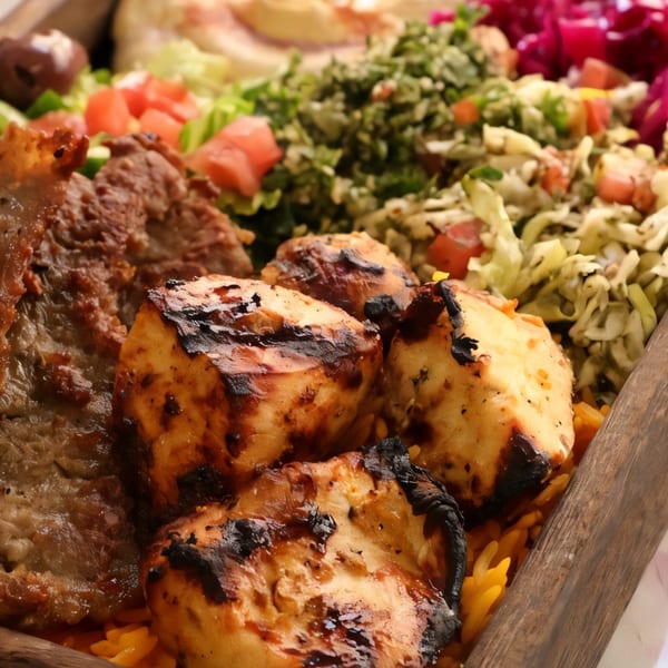 Killer Kabab's grilled chicken and beef kebabs with rice, tabbouleh, and pickled cabbage.